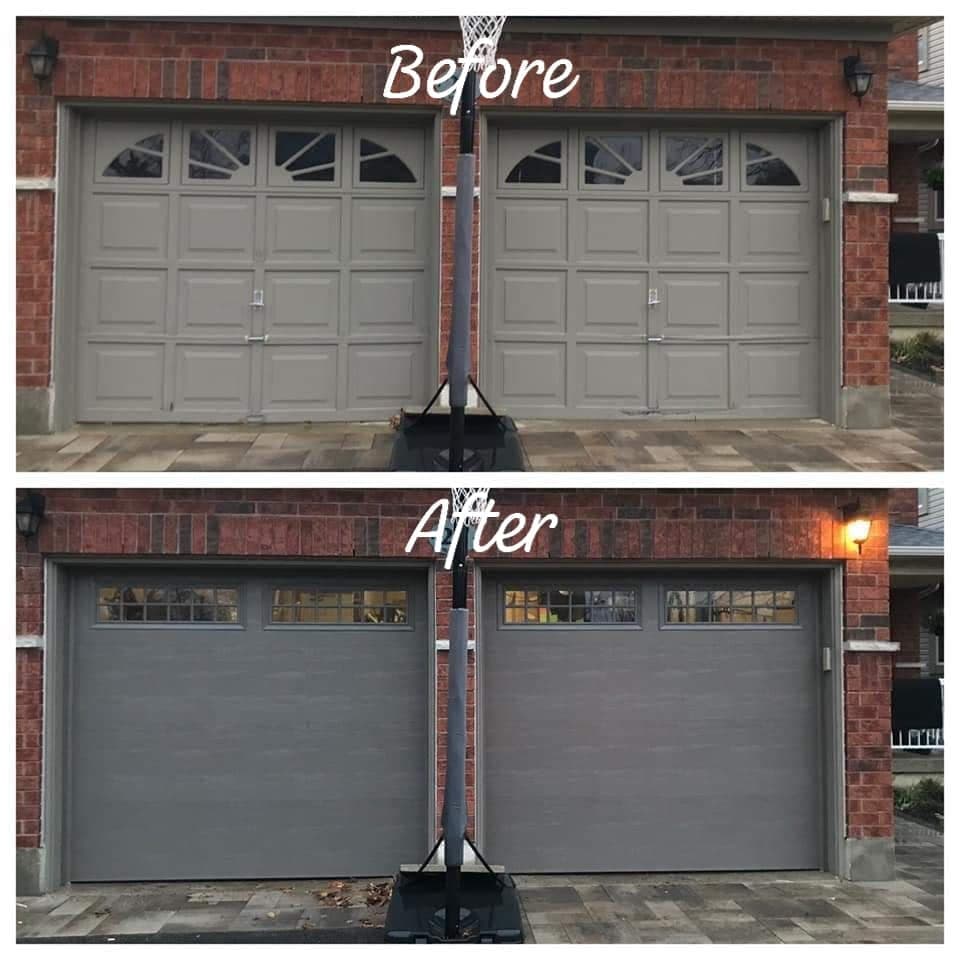Before and after: two grey raised-panel garage doors with sunburst windows on a red brick house, replaced with two smooth grey doors with a row of divided windows along the top.