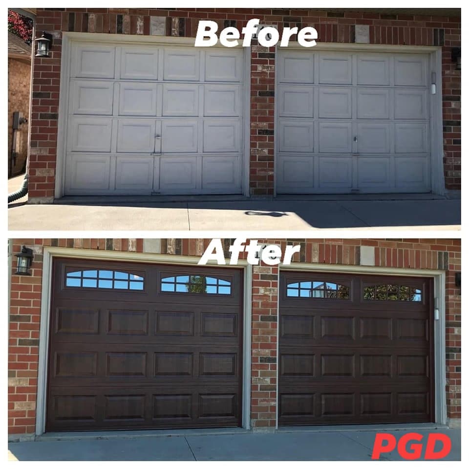 Before and after: two white raised-panel garage doors in a red brick wall, replaced with two dark woodgrain raised-panel doors with arched windows along the top.